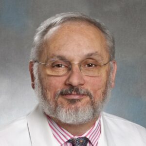 Raphael Bueno, MD, in white coat