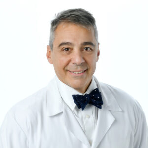 Marcelo DaSilva in white coat and bow tie in front of white background