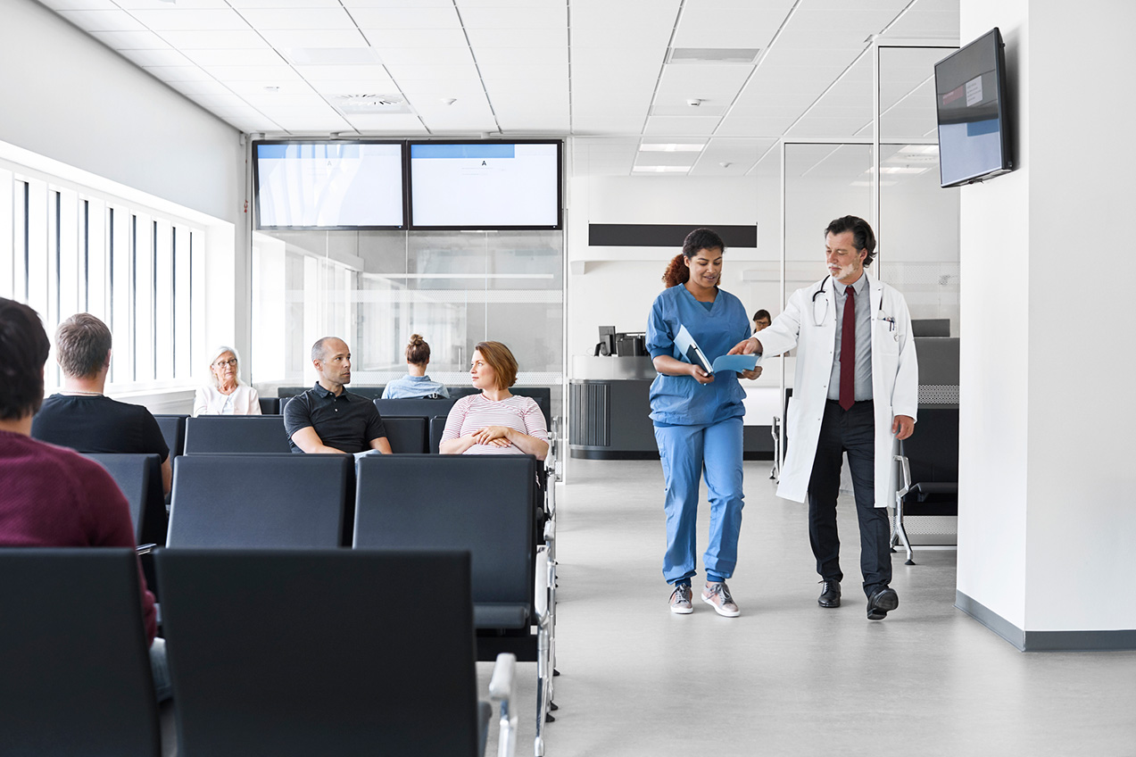 Image of doctor and nurse talking and walking in a mesothelioma clinic