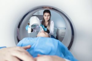 Female radiologist performing radiation on a woman in a hospital gown